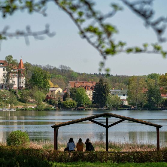 Drei Freunde sitzen im Lunapark am Schermützelsee in Buckow