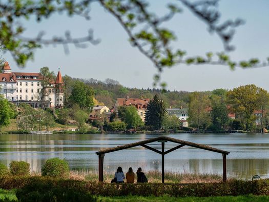 Drei Freunde sitzen im Lunapark am Schermützelsee in Buckow