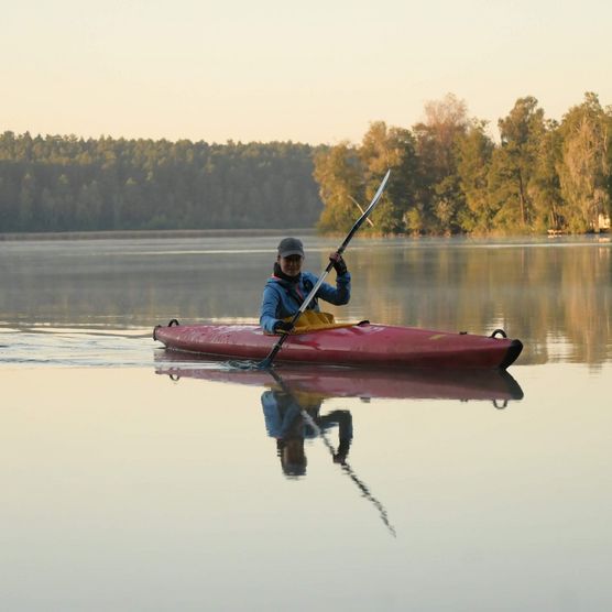 eine Person im Kajak auf dem See im Herbst 